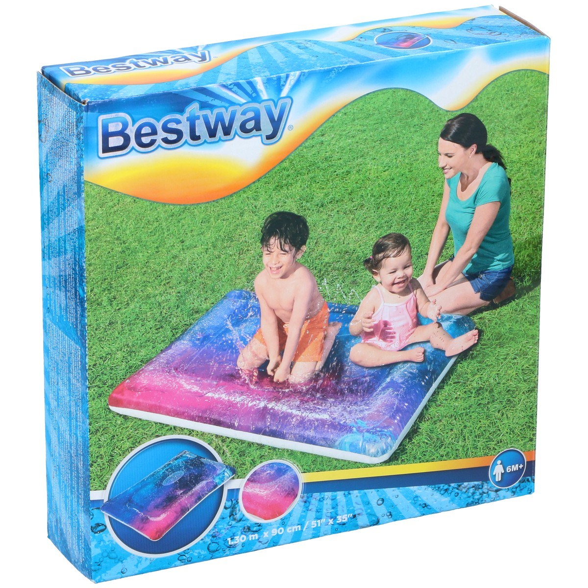 A woman and two children play on a water slide on the grass.