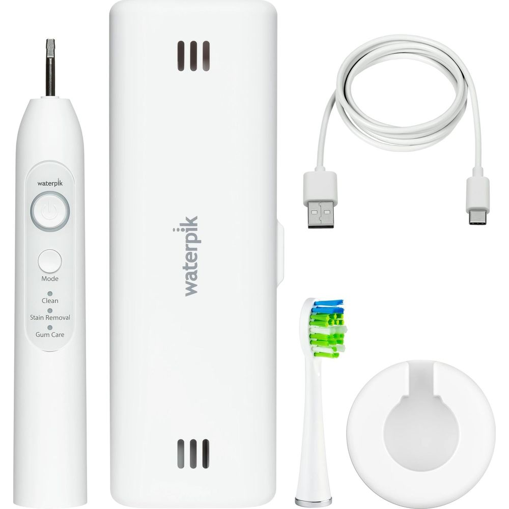 Set spazzolino elettrico bianco con base di ricarica, cavo USB e testina.