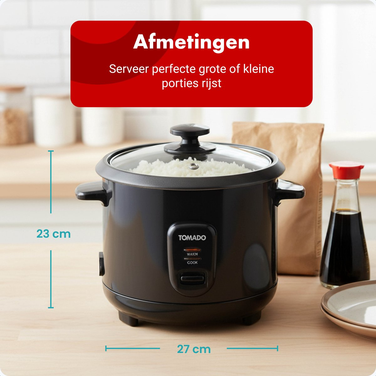 Black rice cooker with lid, filled with rice. Dimensions: 23 cm height, 27 cm width.