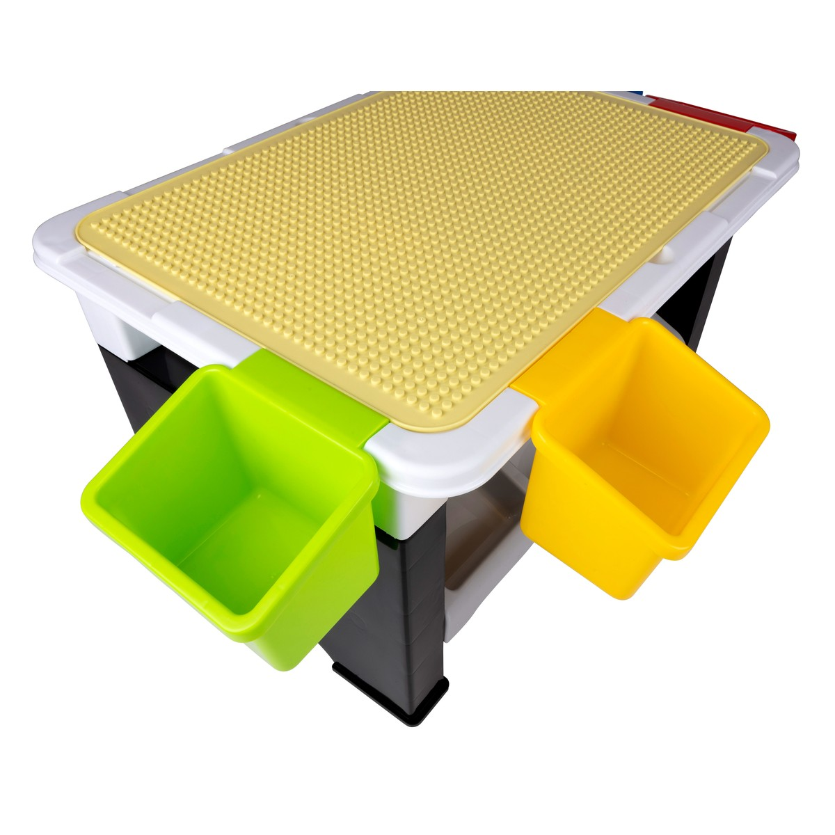 A play table with a yellow studded surface and green and yellow bins.