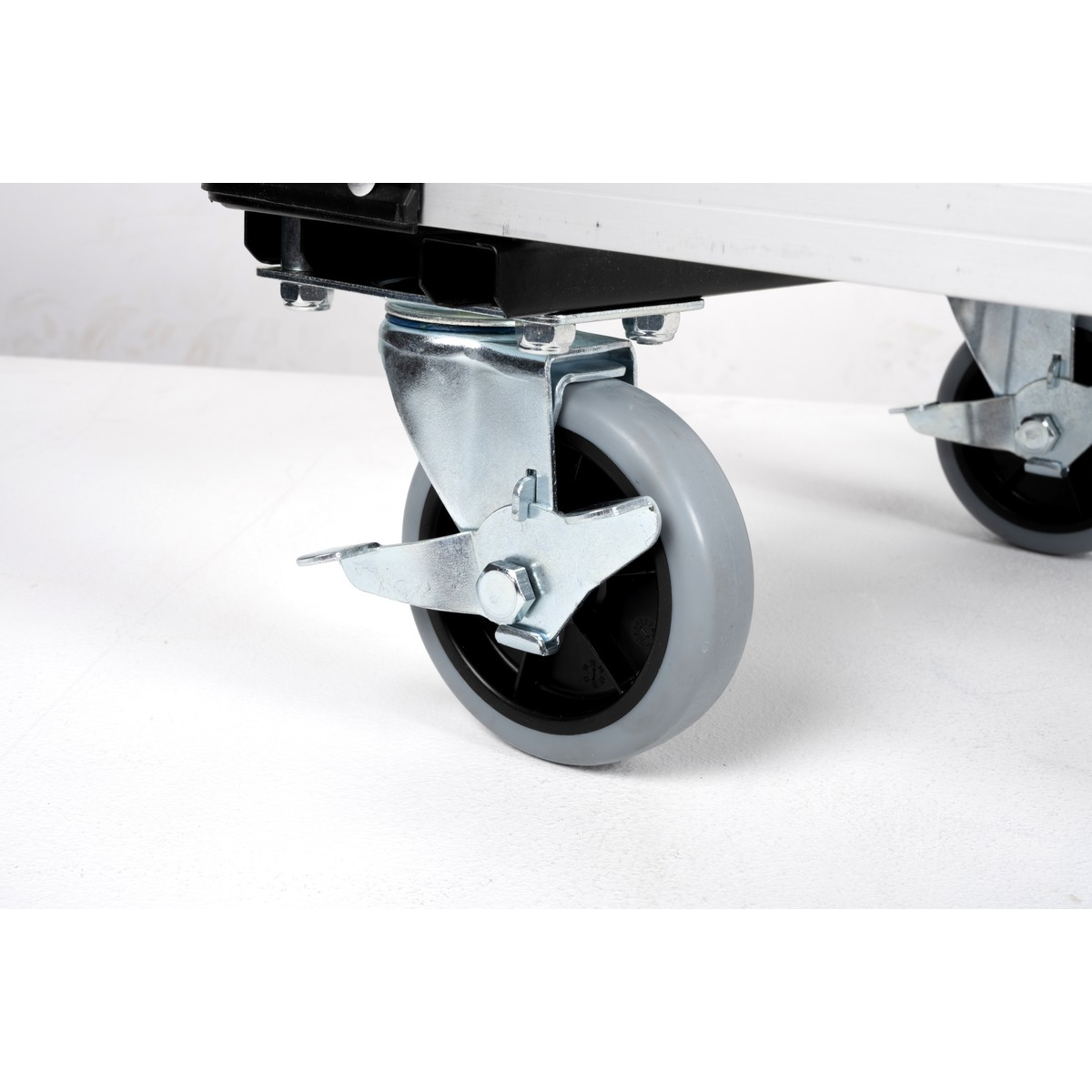 Gray casters with metal mount on a white table.