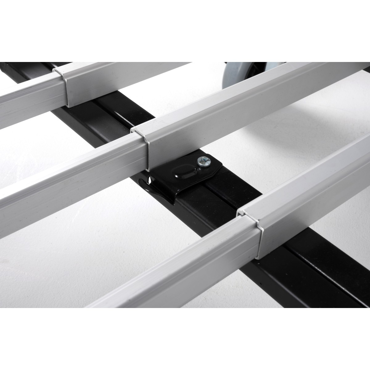 Close-up of an aluminum structure with black connectors and screws.
