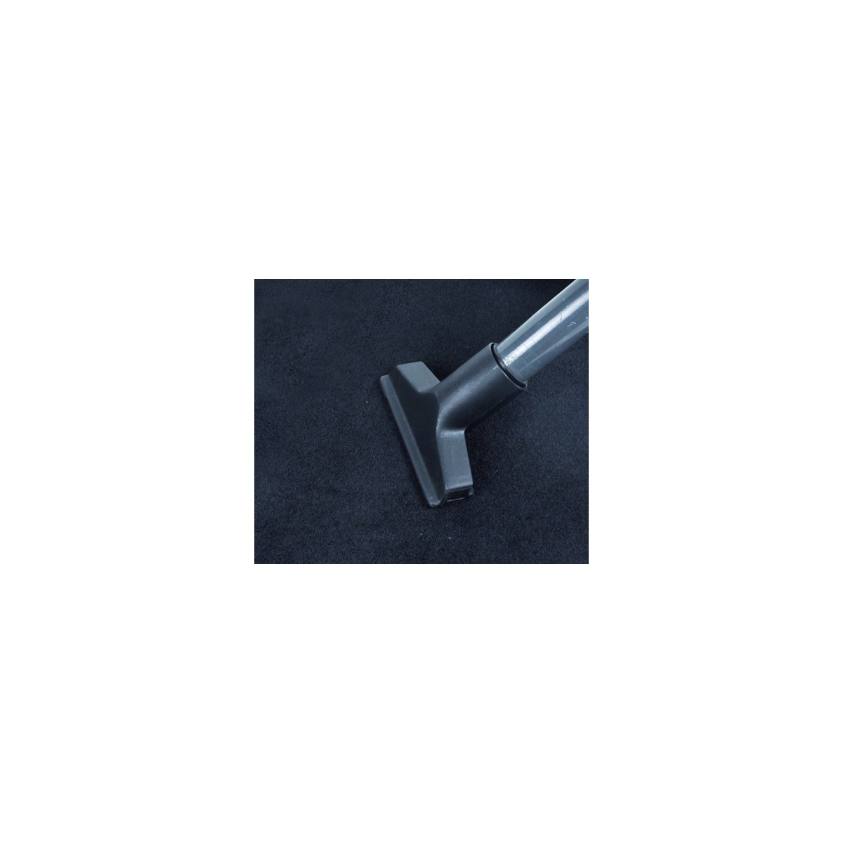 Vacuum cleaner nozzle on dark carpet.