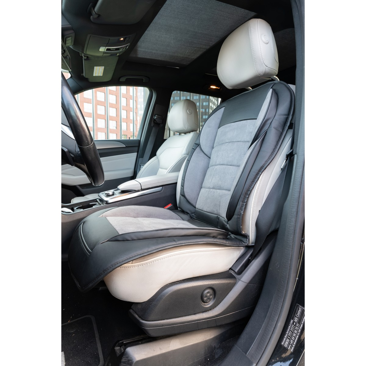 Car interior with a grey and black seat cover, leather and fabric.