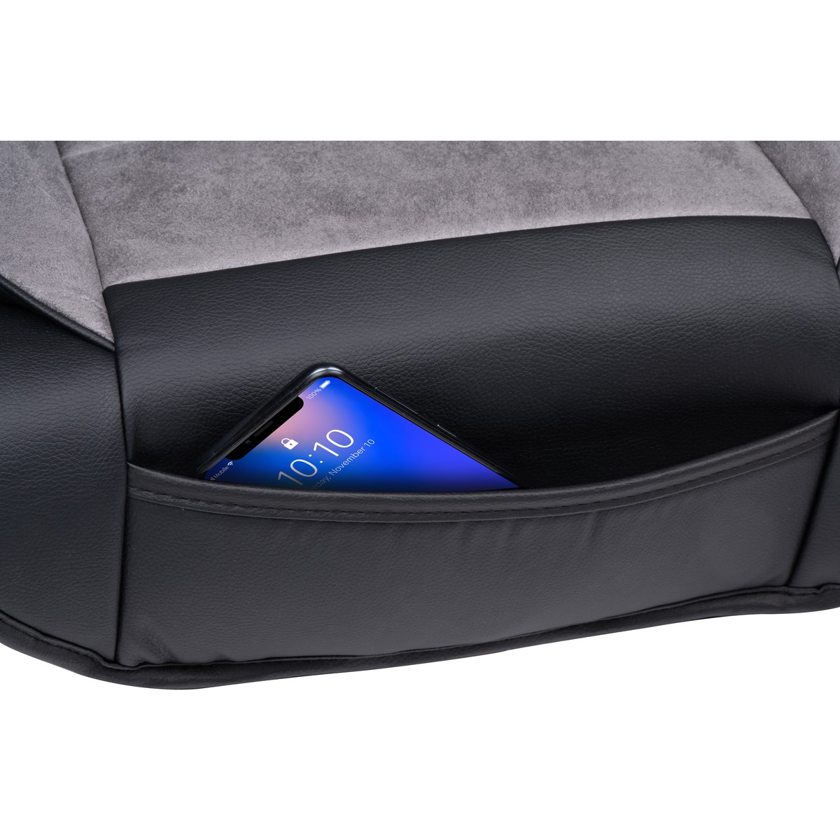 A smartphone is tucked into a black leather pocket on a seat.