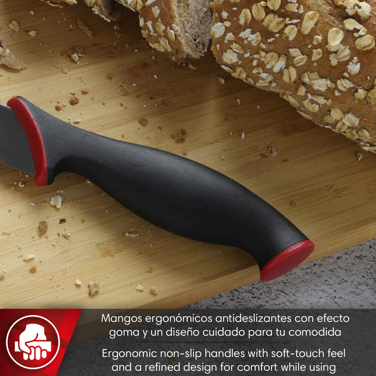 El mango negro de un cuchillo con tapa roja descansa sobre tabla de madera.