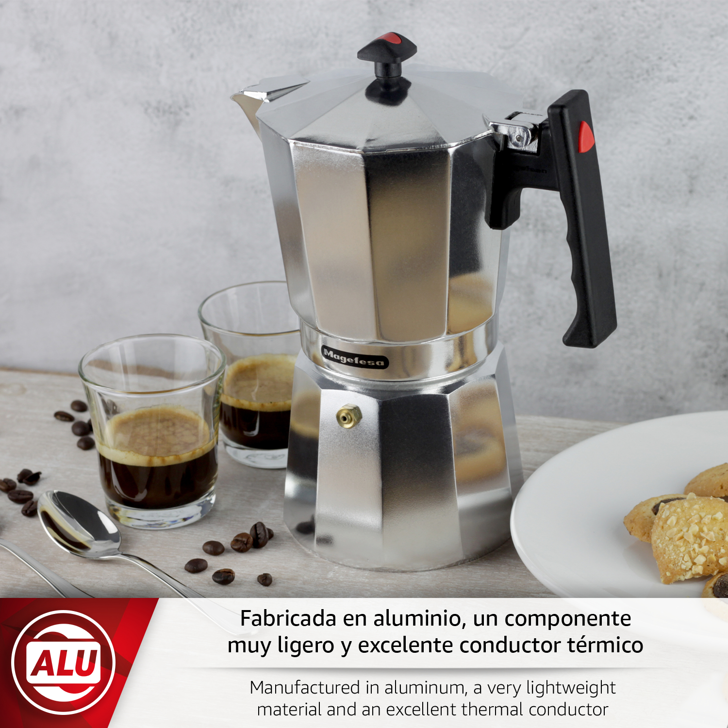 Una cafetera Moka plateada con dos vasos de espresso, galletas y granos de café.