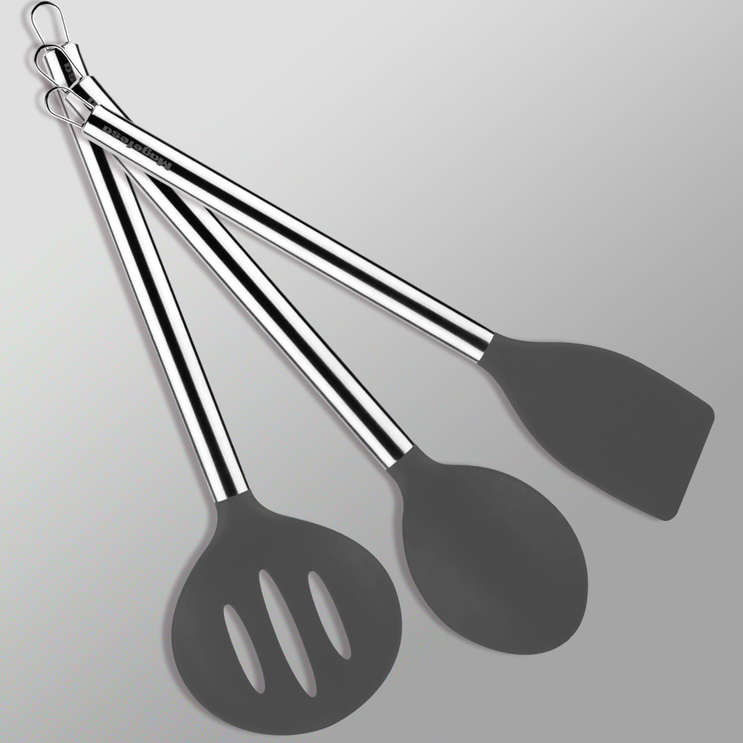 Tres utensilios de cocina grises con mangos de acero inoxidable sobre fondo gris.