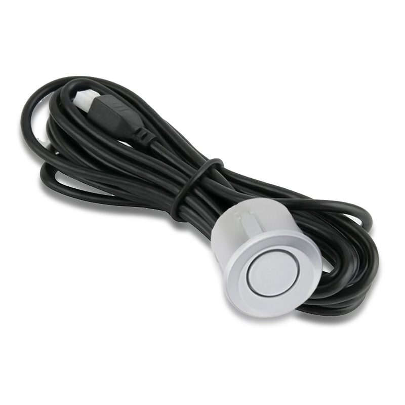 Un sensor de aparcamiento plateado con cable y conector negros.
