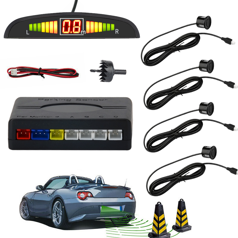 Un kit de sensores de estacionamiento con pantalla, unidad de control, cables, sensores, taladro y conos.
