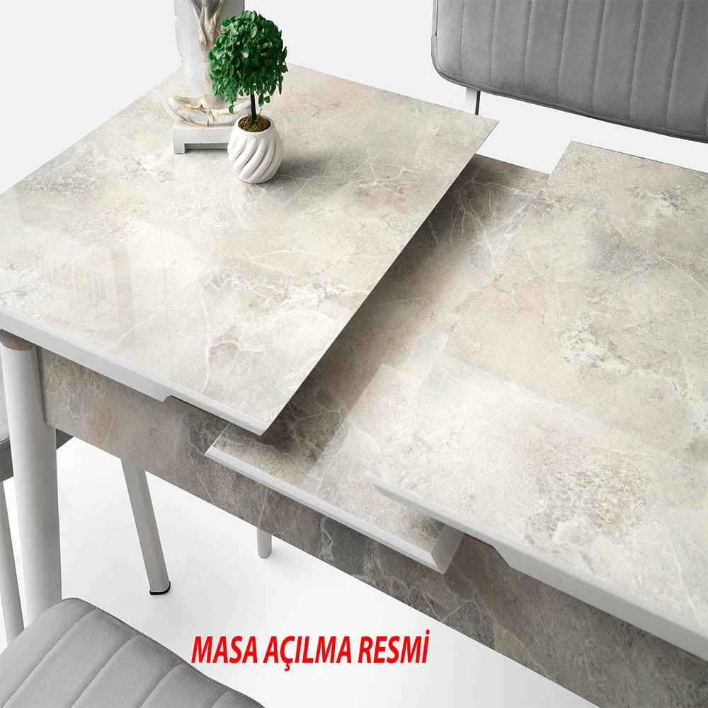 Mermer görünümlü açılabilir masa ve küçük yeşil bitki.
