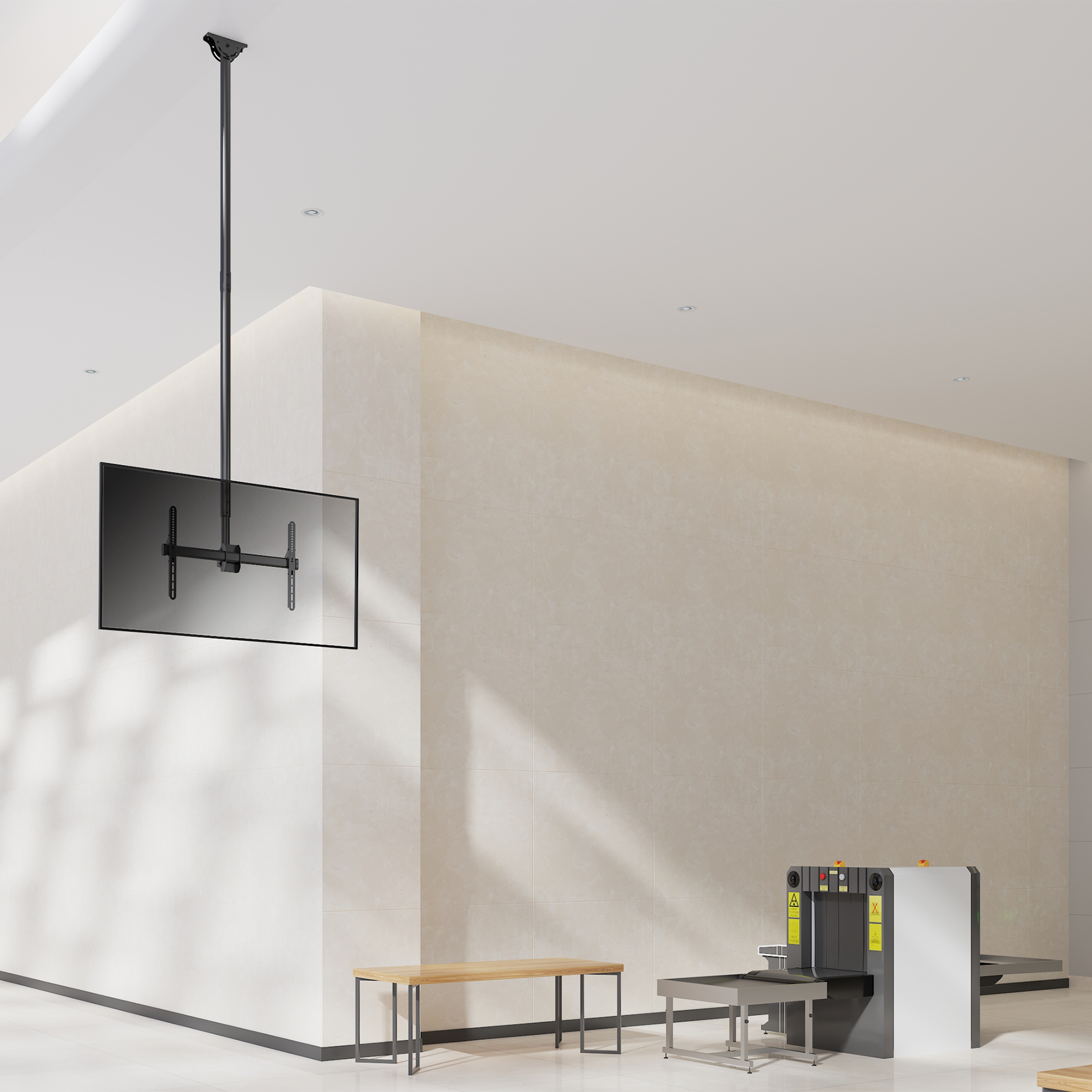A flat screen TV hangs from the ceiling, next to an X-ray scanner and a bench.