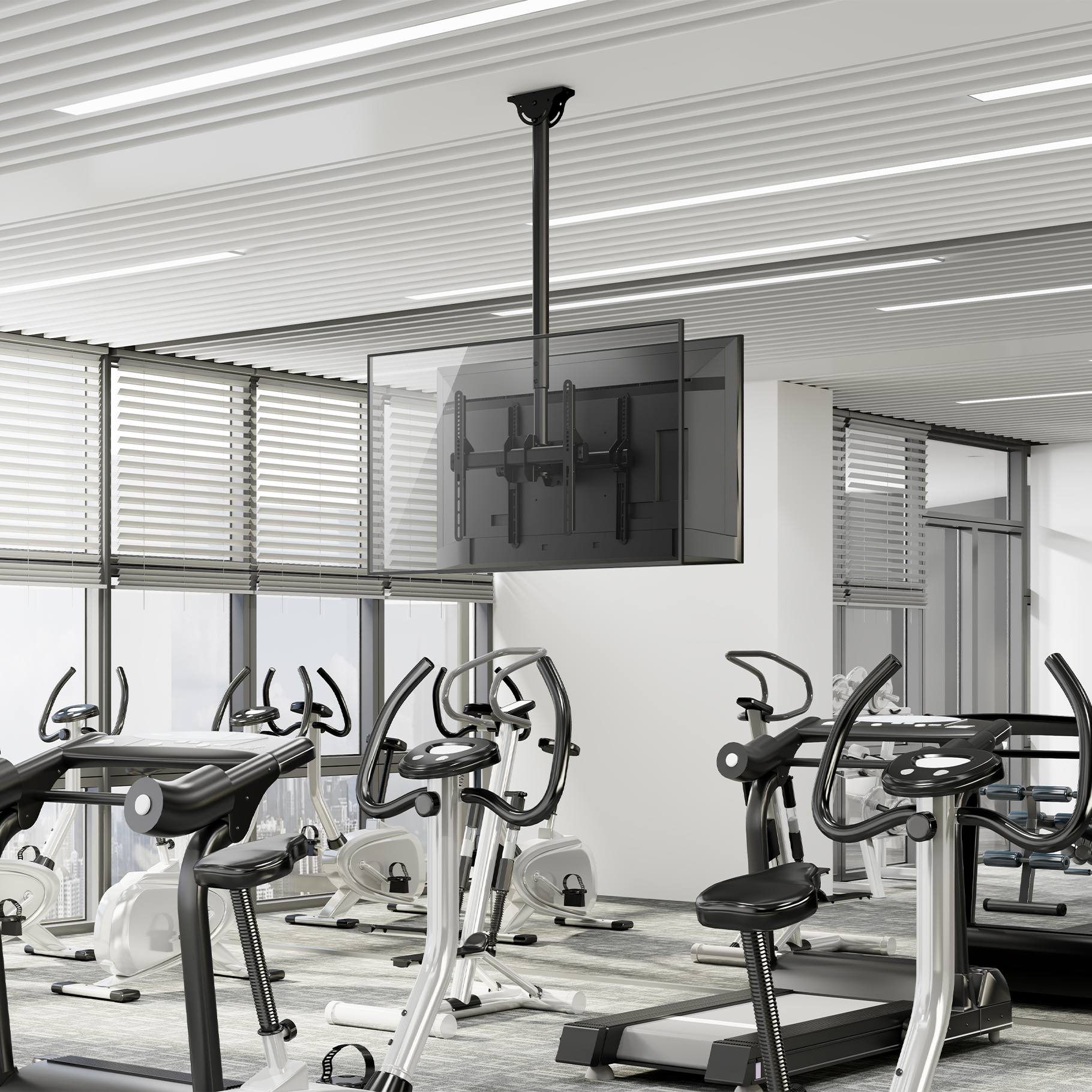 A gym with treadmills, stationary bikes, and a ceiling-mounted TV bracket.