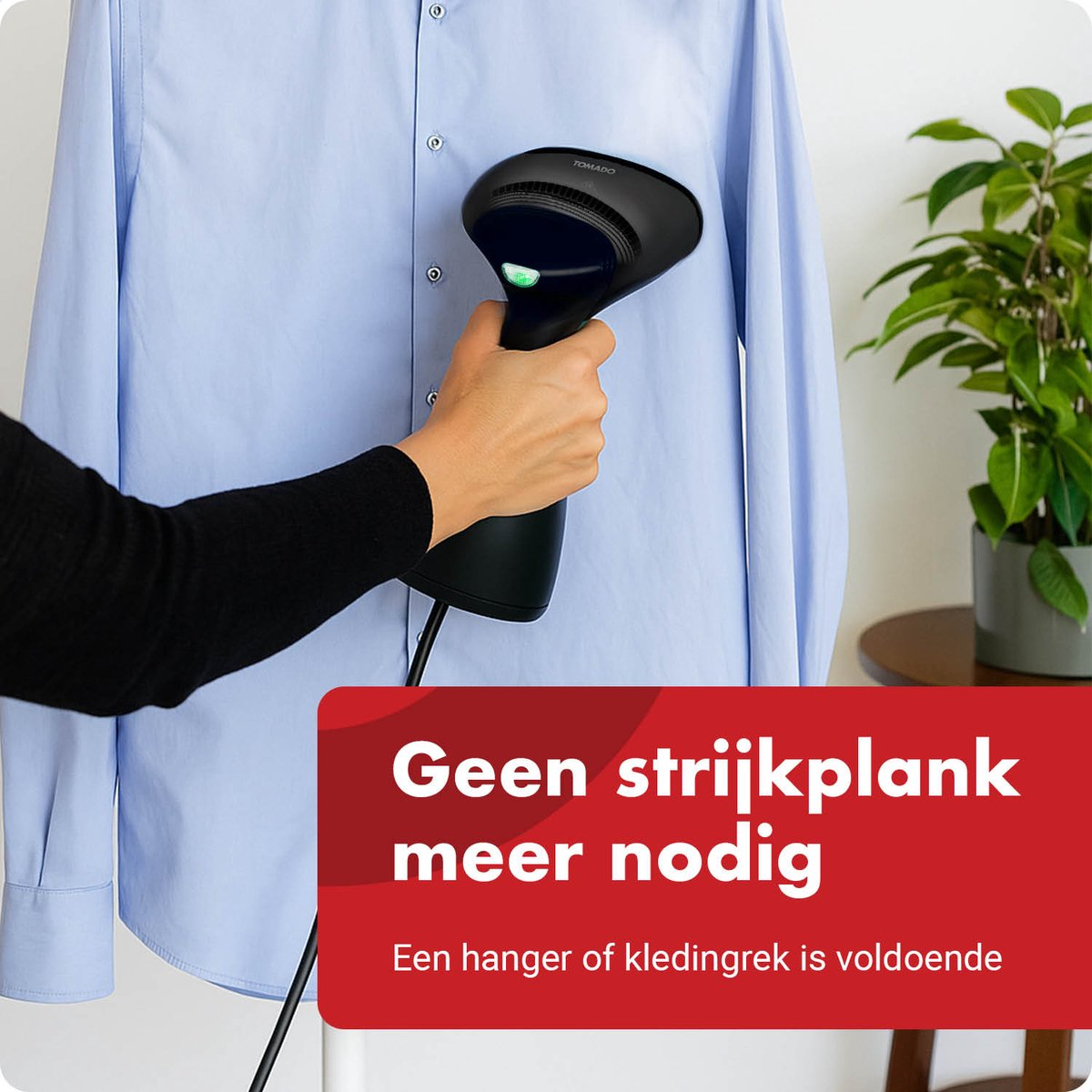 Hand holds garment steamer smoothing a blue shirt collar.