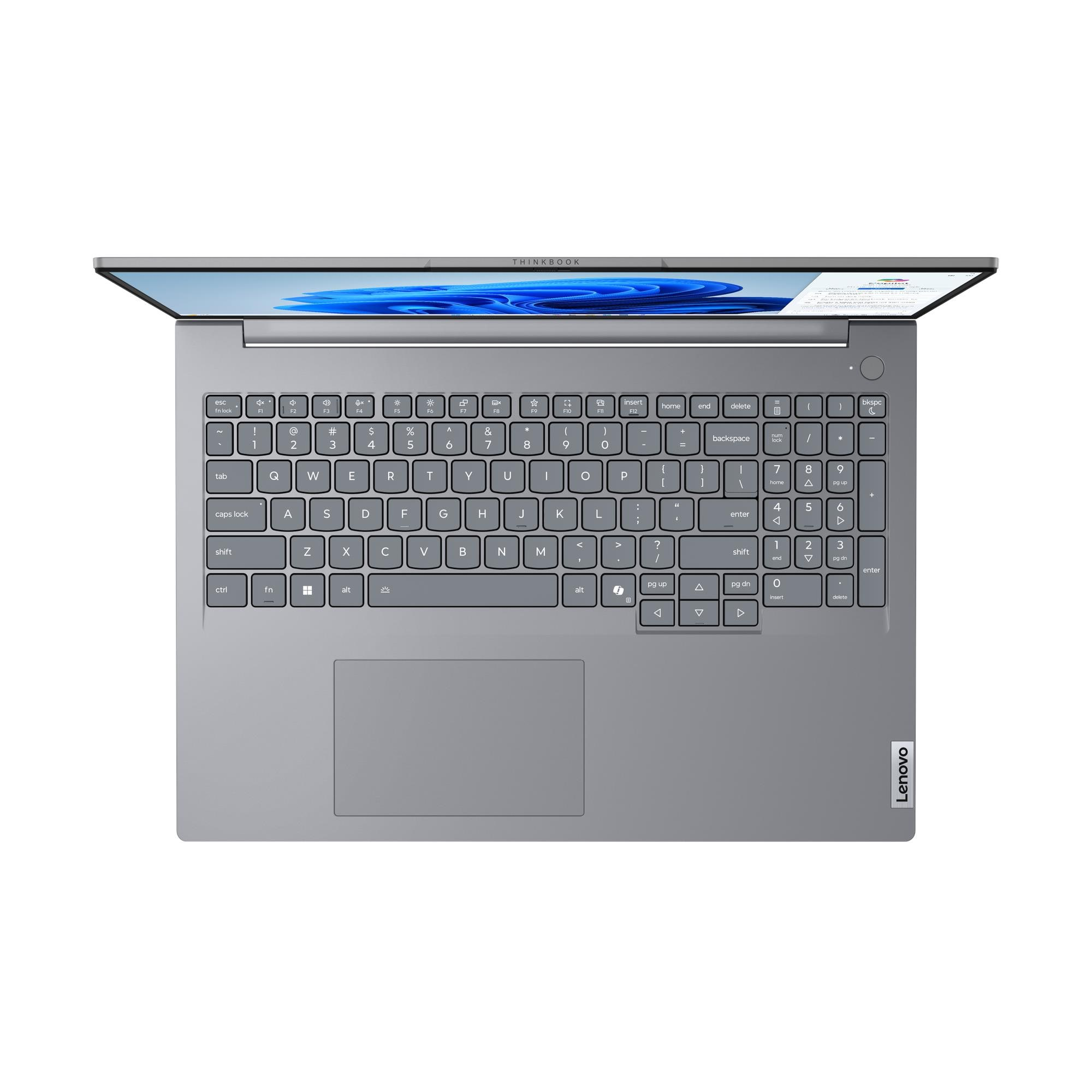 Un laptop argentato aperto con tastiera retroilluminata e touchpad.