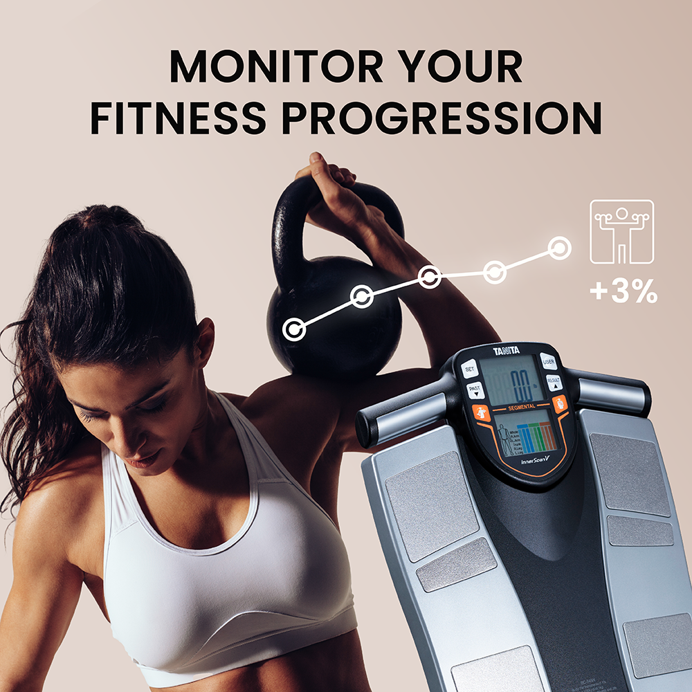 Woman holding kettlebell with body composition scale showing progress.