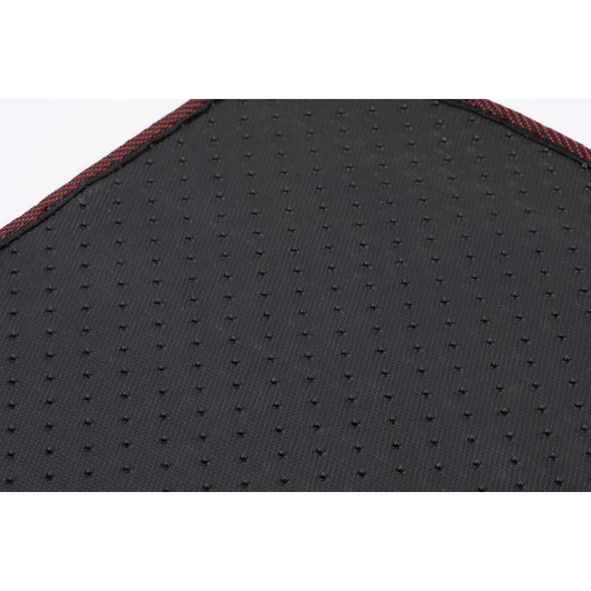 Back of a floor mat with anti-slip nubs and a red border.
