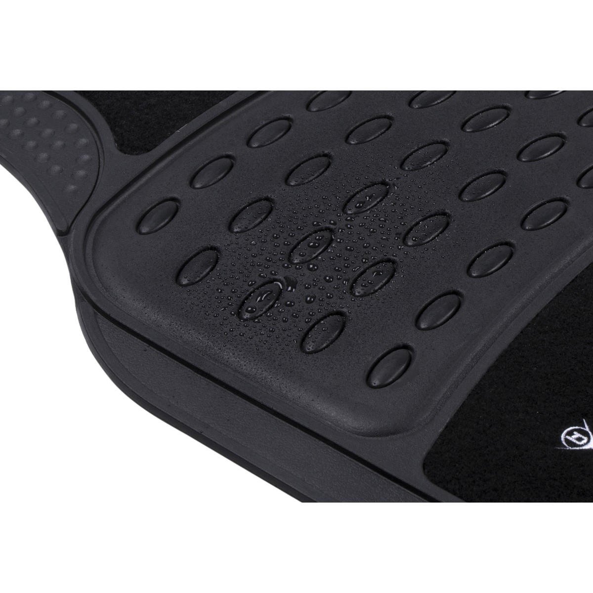 Black car mat with raised oval pattern and water droplets.