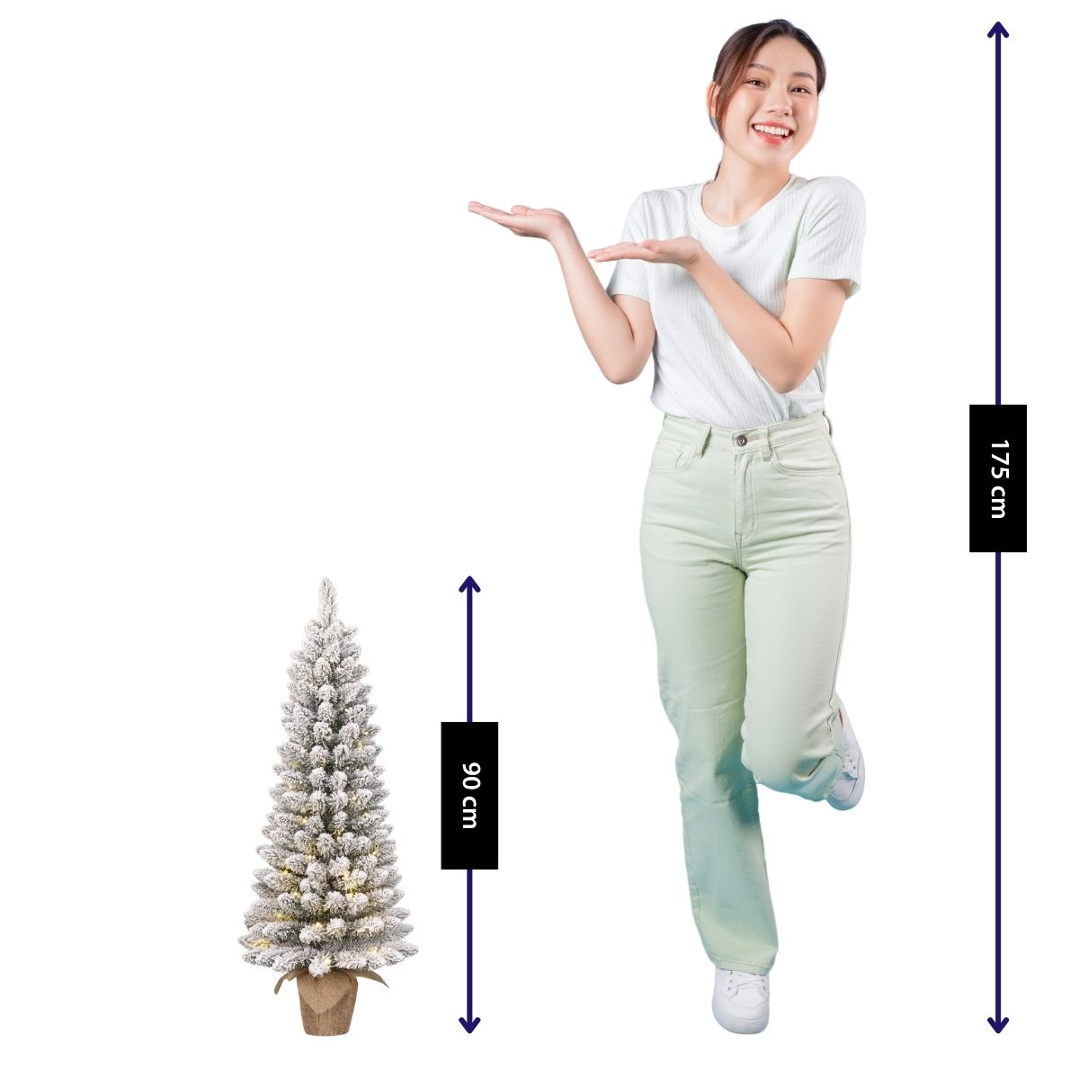 A woman stands next to a 90 cm tall, lit Christmas tree.