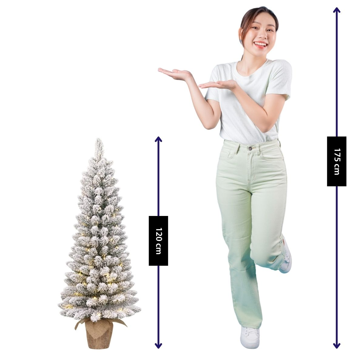 A woman stands next to a 120cm tall decorated Christmas tree.