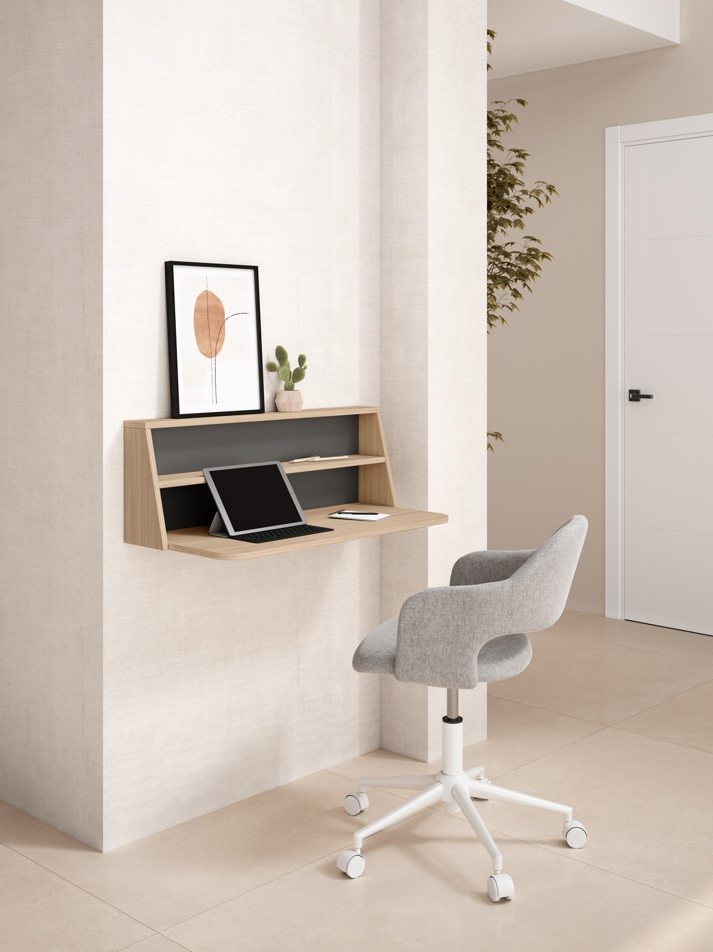 Un escritorio minimalista de pared con portátil, silla y arte enmarcado.