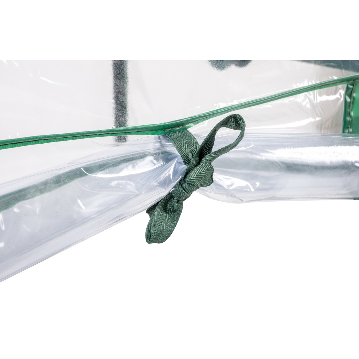 A green ribbon is tied around a clear plastic cover enclosing a shiny object.