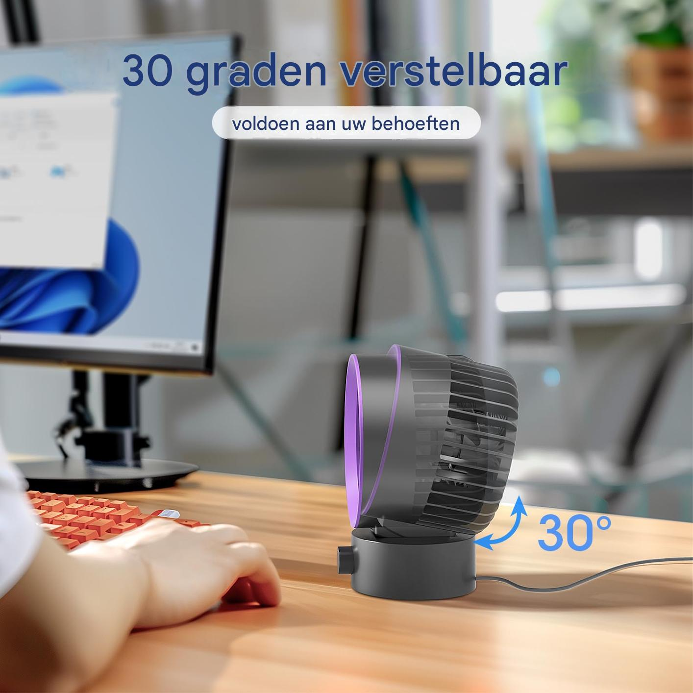 Ein kleiner schwarzer Ventilator mit lila Akzenten steht auf einem Schreibtisch.
