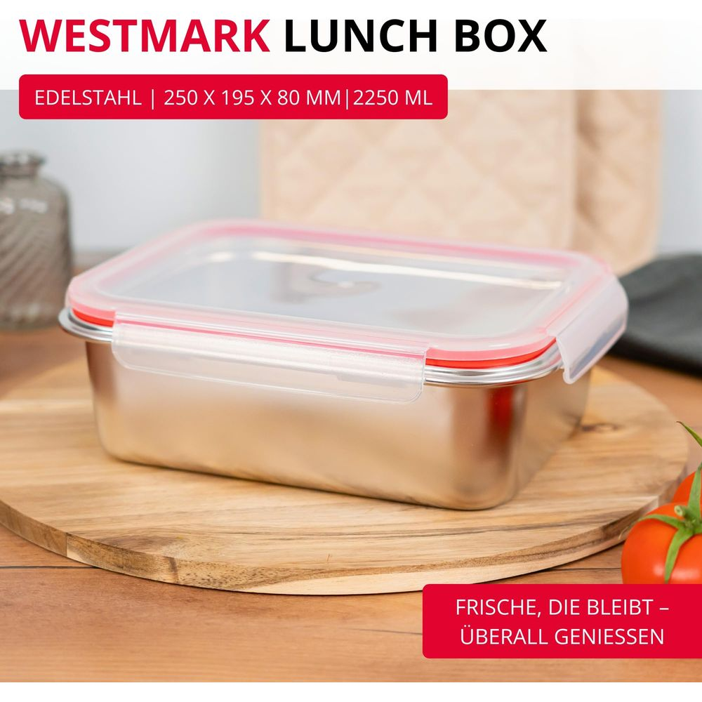 Edelstahl-Lunchbox mit rotem Dichtungsring und transparentem Deckel auf Holzbrett.