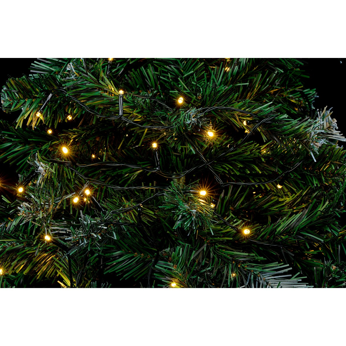 Green Christmas tree with string lights, close-up.