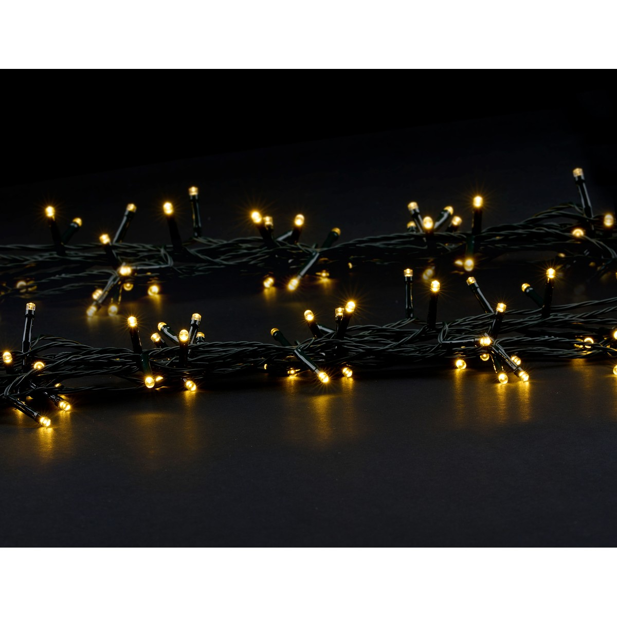 A string of lights with many small yellow lights on a black background.