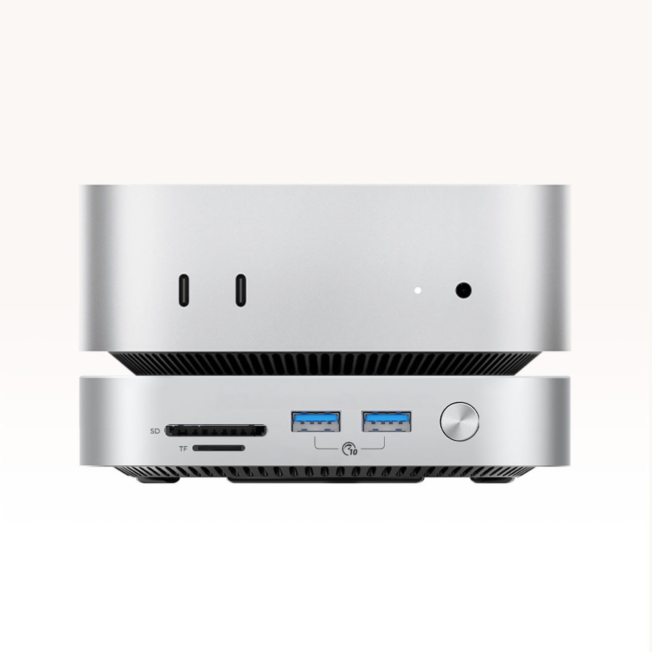 Srebrny mini PC z portami: SD, TF, USB i przyciskiem zasilania.