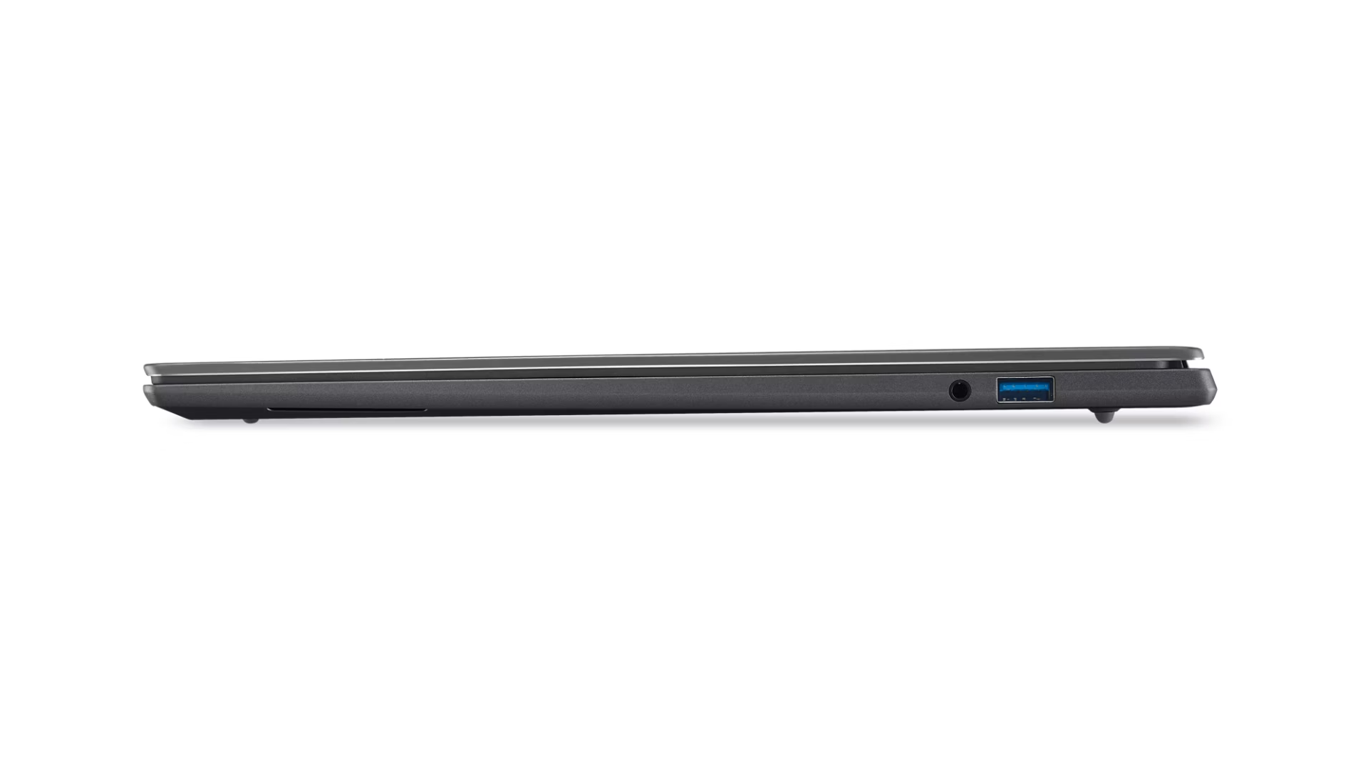 Vista laterale di un laptop grigio chiuso con porte USB e cuffie.