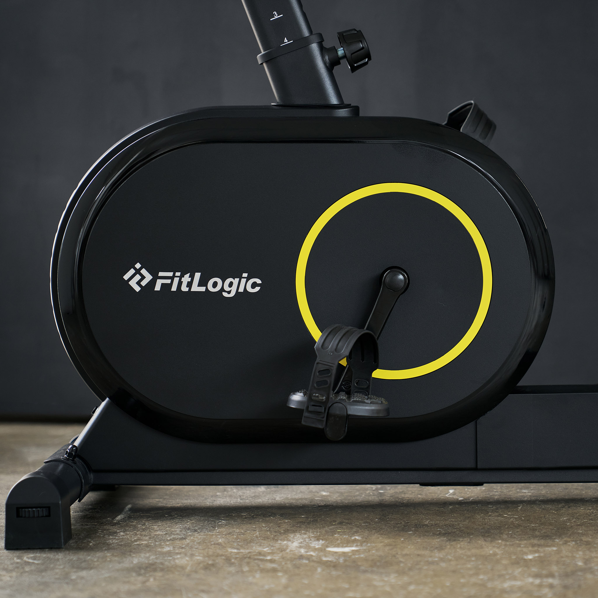 Schwarzer Heimtrainer mit gelbem Kreis und FitLogic-Logo. Naheaufnahme.