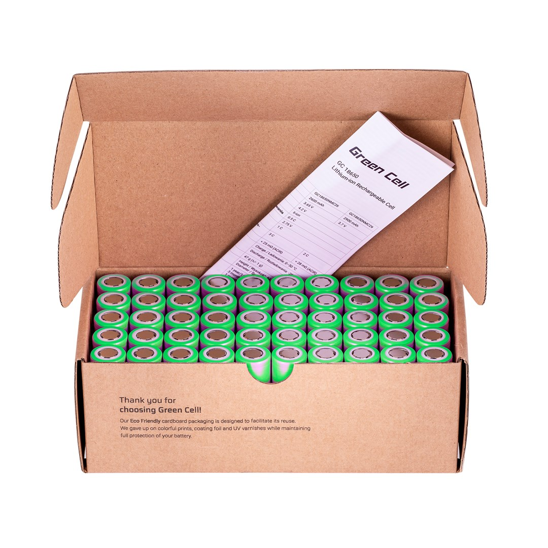 An open cardboard box filled with green batteries and a specification sheet.