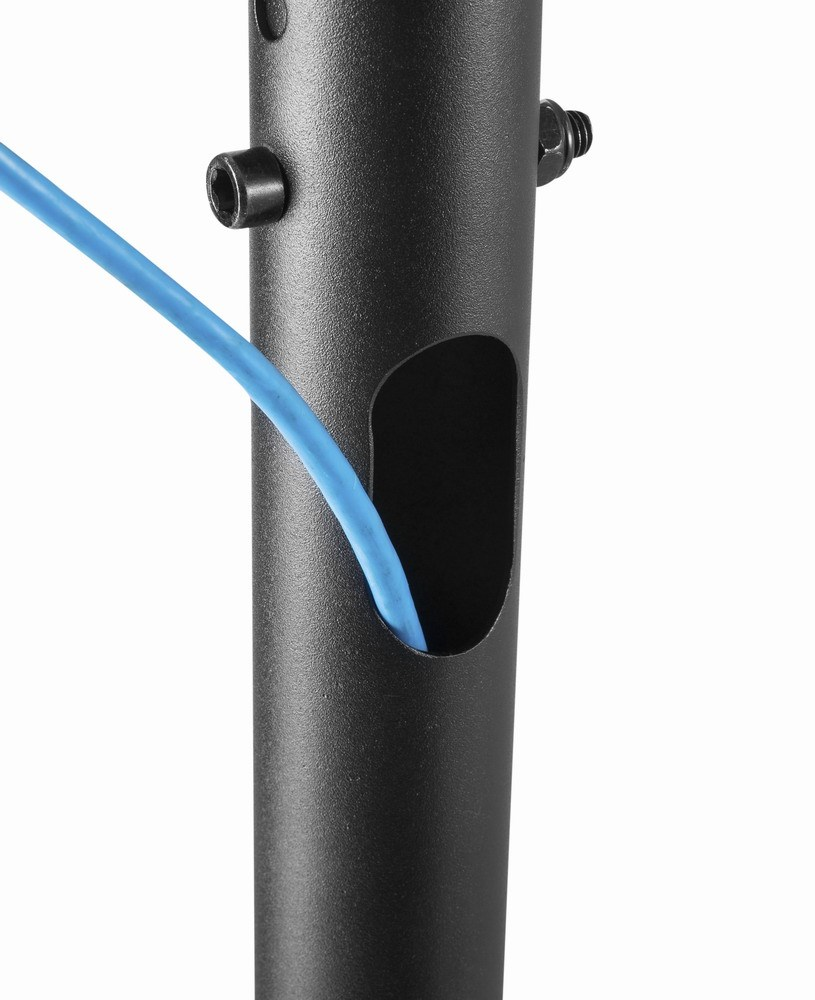 A blue wire is threaded through an opening in a black metal pole.