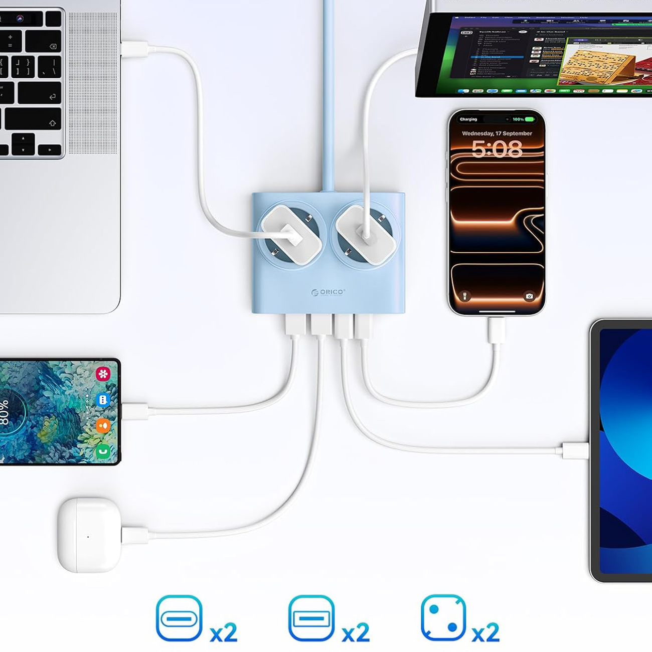 Niebieska stacja ładująca łączy laptopa, telefon, słuchawki i tablet.