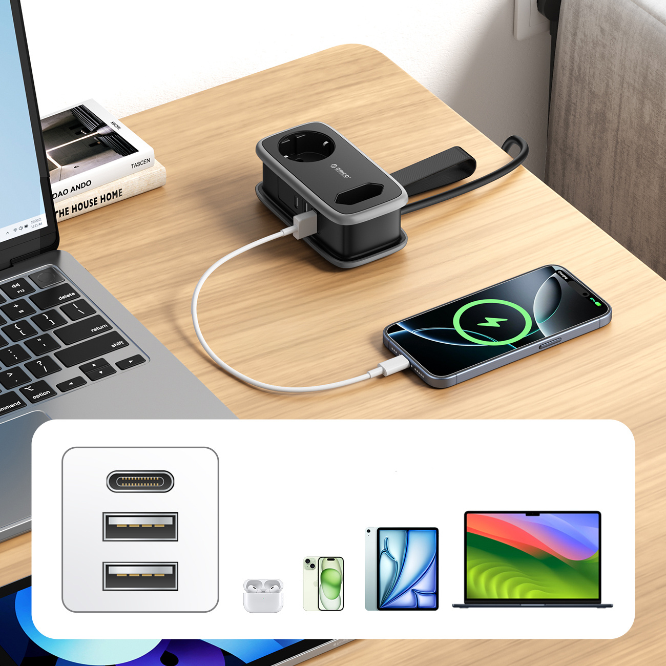 Laptop, listwa zasilająca z portami USB i telefon na biurku.