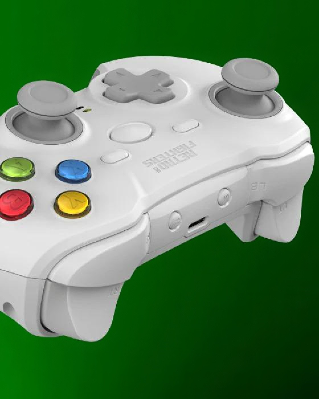 Biay kontroler do gry z szarymi przyciskami i joystickami na zielonym tle.
