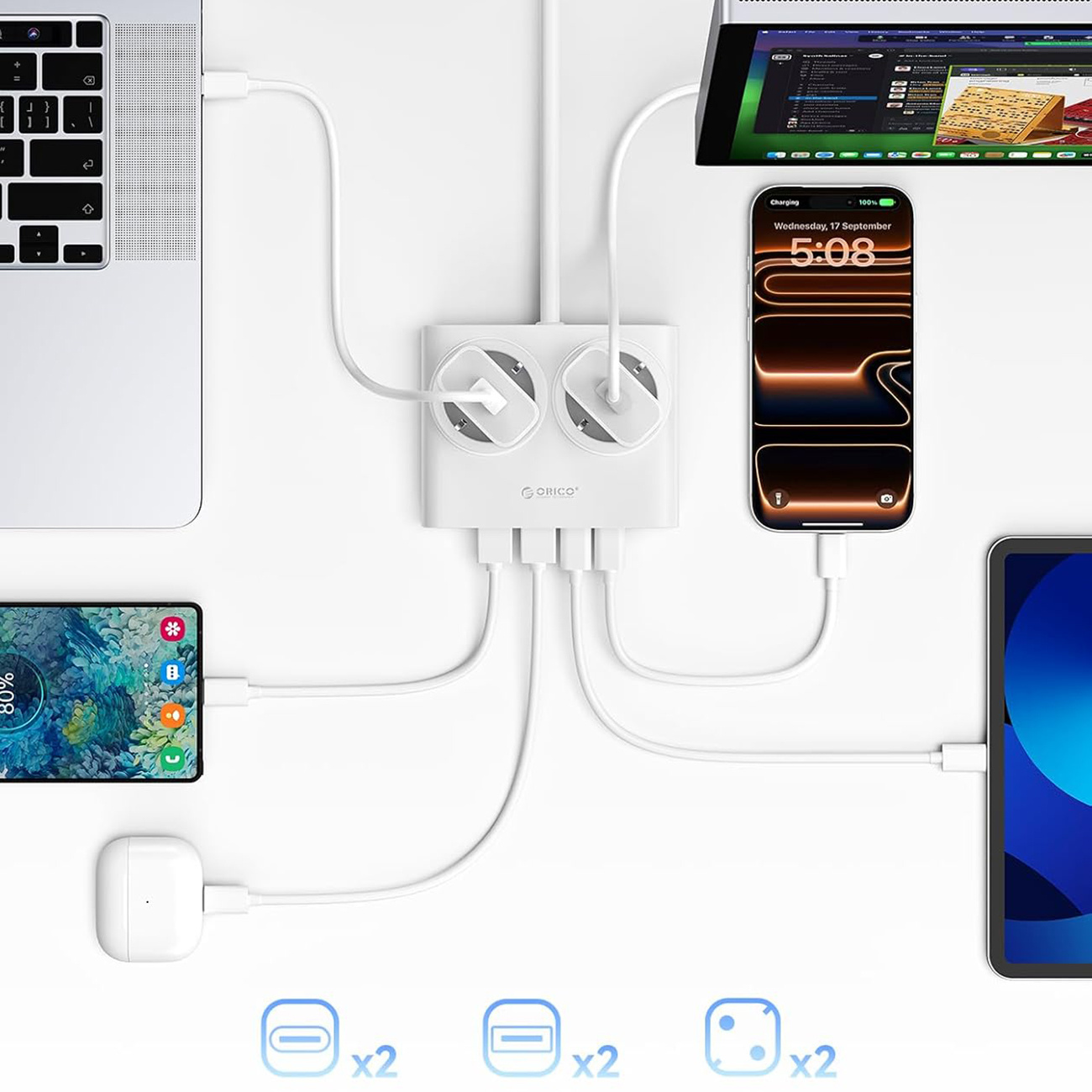 Biała stacja ładująca podłączona do laptopa, smartfona, słuchawek i tabletu.