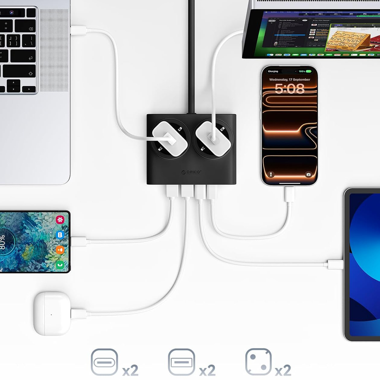 Czarna listwa zasilająca ładuje laptopa, telefon, tablet i słuchawki.