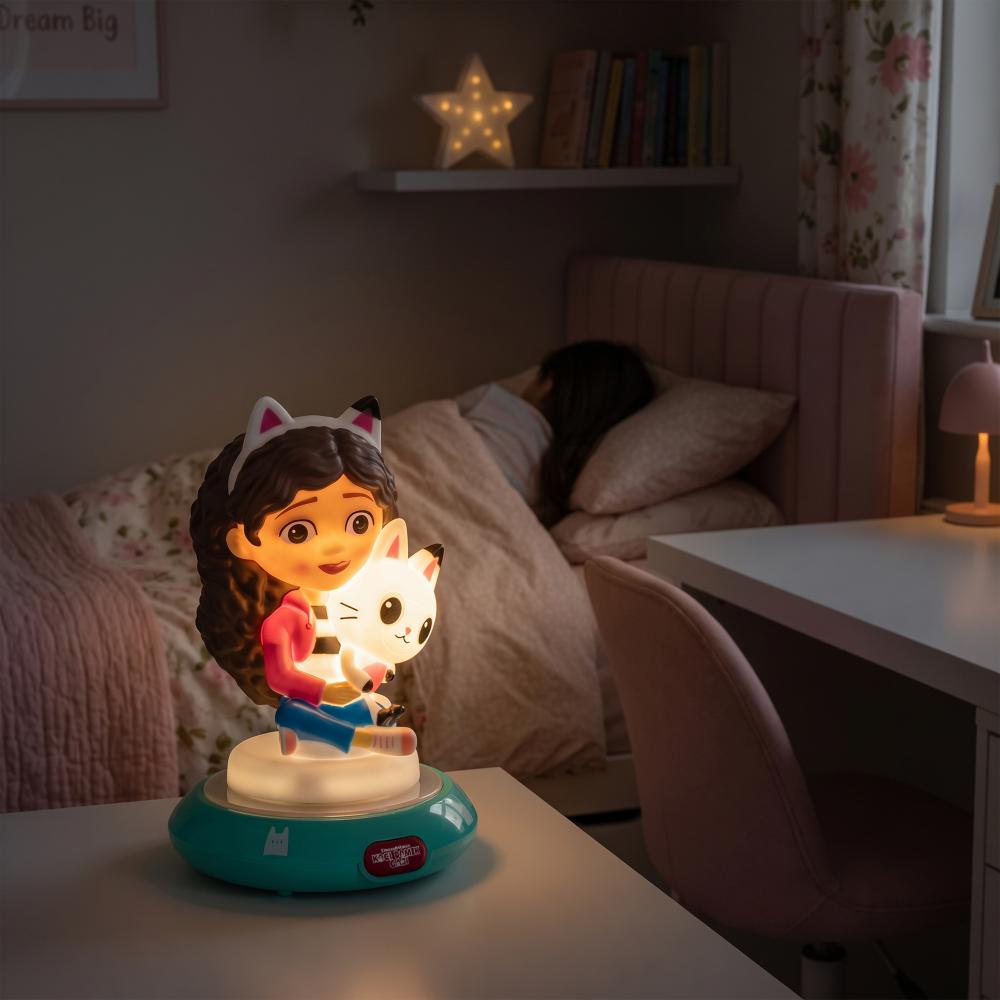 Lampka nocna z dziewczynką i kotem na stoliku nocnym obok śpiącego dziecka.