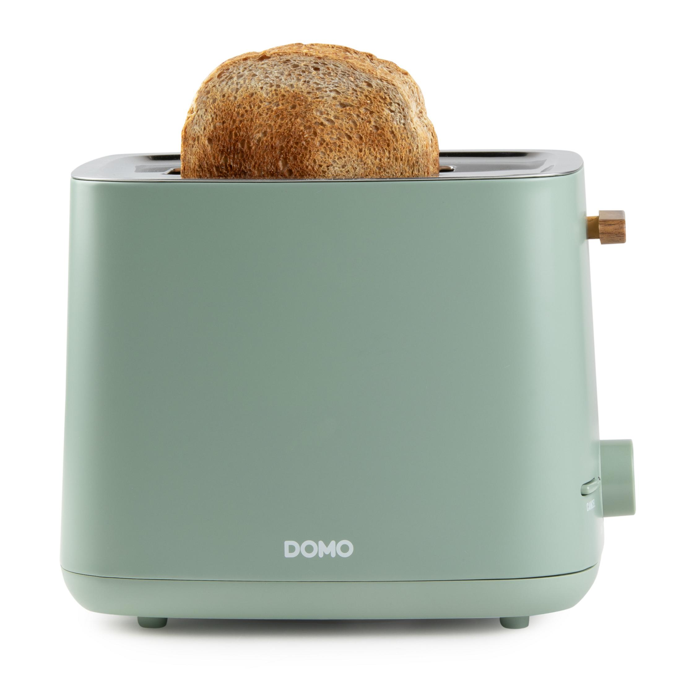 Ein grüner Toaster mit einem Toastbrot, das herausragt.