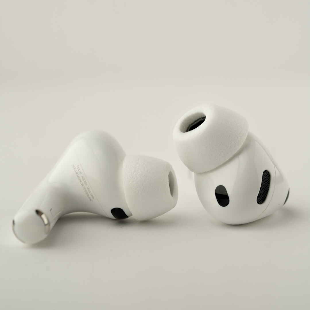 Zwei weiße Apple AirPods Pro auf hellem Hintergrund.
