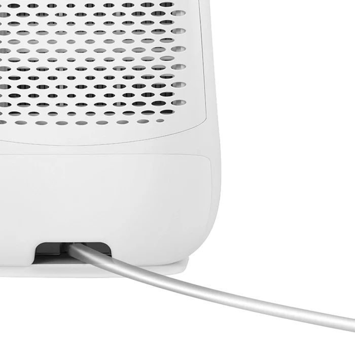Nahaufnahme eines weißen Geräts mit einem silbernen Kabel, das aus einer Öffnung kommt.