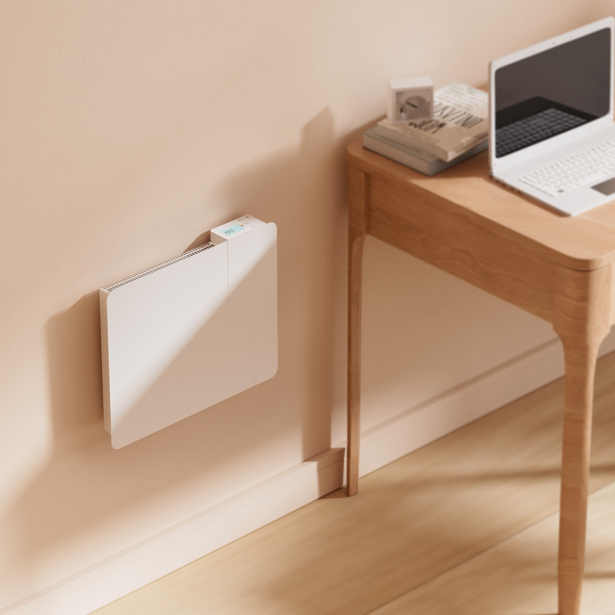 Ein weißer Heizkörper an einer Wand mit einem Laptop auf einem Holztisch.