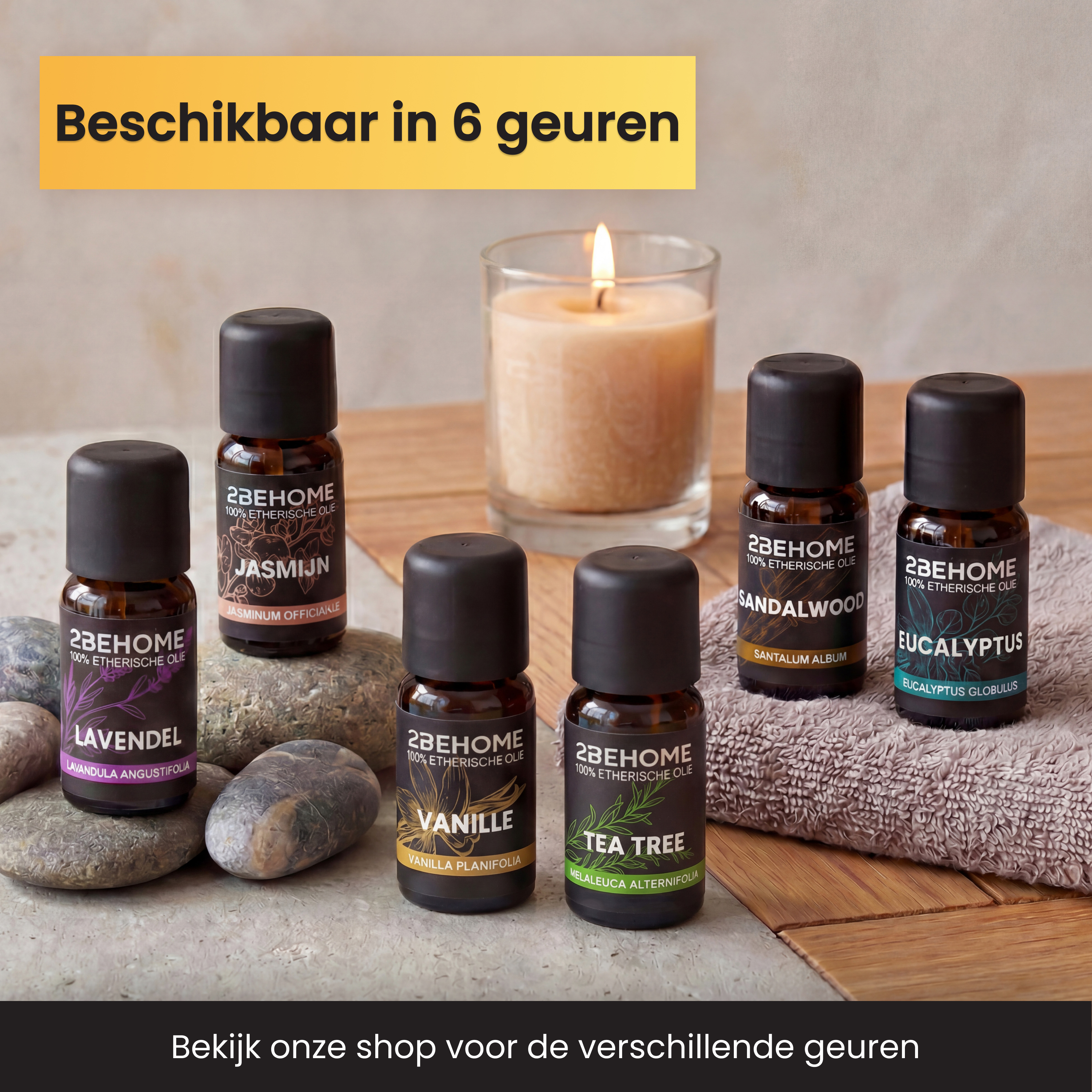 Fünf Flaschen ätherisches Öl von 2BEHOME neben einer brennenden Kerze auf Holz.