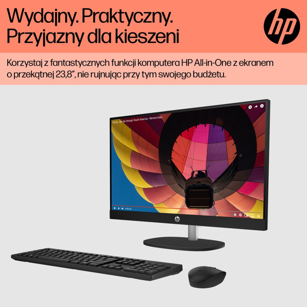 Komputer HP All-in-One z klawiaturą i myszką wyświetla kolorowy balon na ogrzane powietrze.