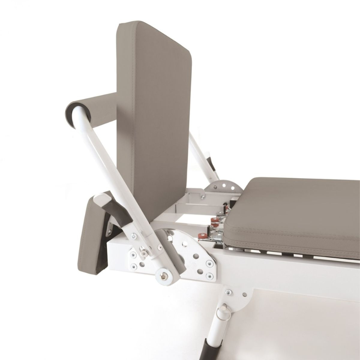 A grey Pilates machine with a white metal frame, cushions, and springs.