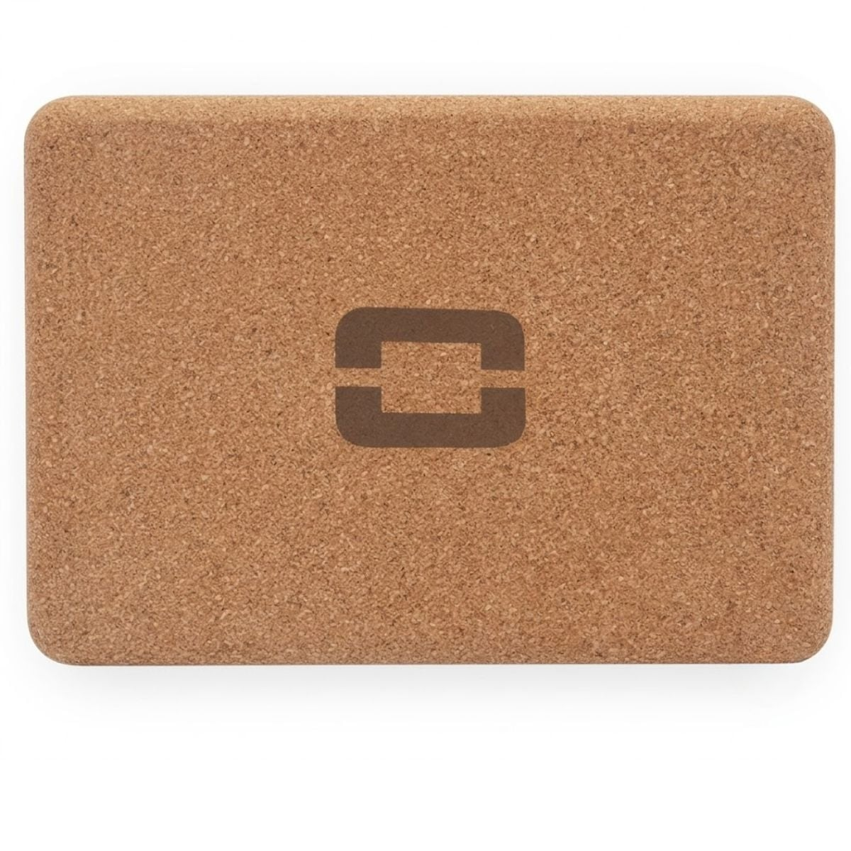 A brown cork yoga block with a darker logo.