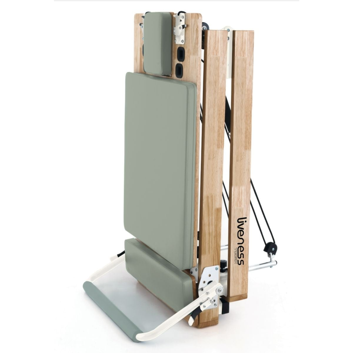 A folded pilates reformer with a wooden frame and grey padding.